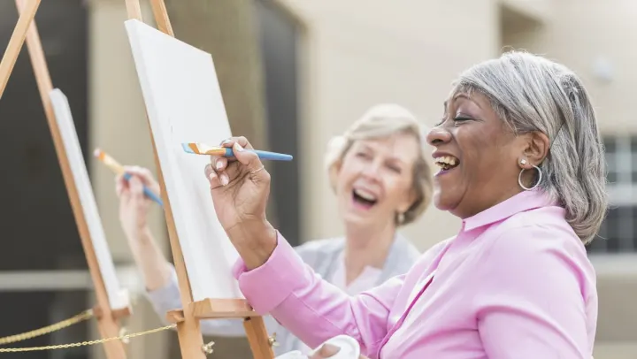 elderly women painting joyfully