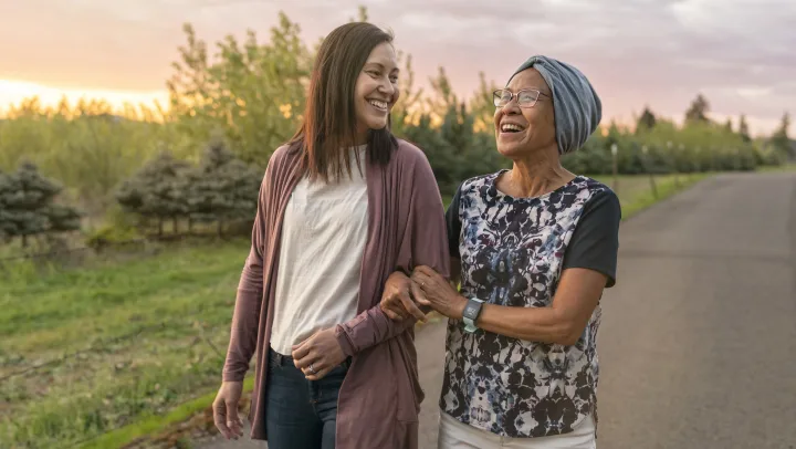 mother and daughter on a walk together with smiles